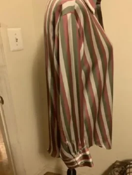 Side view of a pink and green striped long-sleeve shirt on a mannequin.