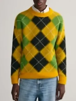 A yellow fuzzy sweater with green and black argyle pattern worn with jeans.