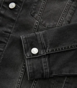 Close-up of the buttoned cuff on a jean jacket black sleeve, showcasing the quality finish of this essential men black denim jacket piece.