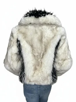 Rear view of a plush cream jacket on a mannequin showing subtle dark vertical framing panels along the sides and a prominent high collar.