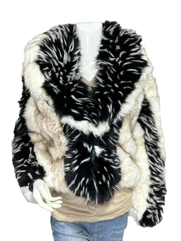 Front view of a bold black-and-white patterned jacket featuring an oversized shawl collar and long shaggy texturing.