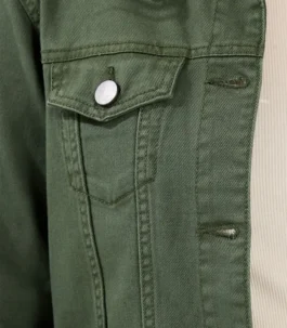 Close-up of a green denim jacket showing high-quality stitching, metal button closure on the chest pocket, and durable green jacket denim fabric.