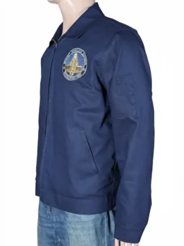 Close-up of the Chris Pratt Mercy 2026 jacket showing the navy blue cotton material and the detailed chest emblem.