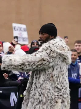 A profile shot of the Randy Moss game fur coat and Randy Moss Texans vs Patriots coat style worn during a live outdoor sports production.