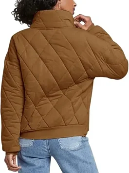Rear view of a model wearing the Brown Dolman Quilted Jacket showcasing the relaxed fit, quilted back panel, and comfortable ribbed hemline.