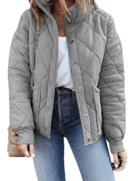 A stylish model wearing a Women's Grey Dolman Quilted Jacket paired with jeans, showcasing the open-front button design and casual chic style.