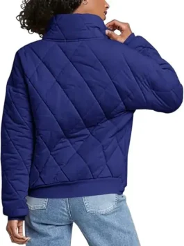 Rear view of a woman wearing a Navy Dolman Quilted Jacket featuring a high collar, oversized fit, and classic diamond-shaped quilted embroidery.