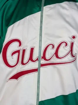 Front view of a green and white lightweight jacket featuring a high stand-up collar and full-length front zipper.