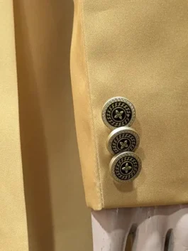 High-quality gold blazer featuring open hem cuffs and pockets.