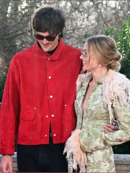 Margot Robbie wears a John Galliano Long Trim Coat with Jacob Elordi during the Wuthering Heights London tour.