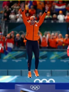 Jutta Leerdam speed skating jacket 2026 Winter Olympics celebration as she jumps on the podium in her Team Netherlands orange puffer jacket.