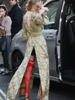 Rear view of the John Galliano feather collar long coat on Margot Robbie as she arrives at the London photocall event.