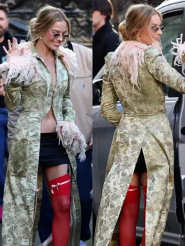 Detail view of Margot Robbie's long coat London photocall look by John Galliano, showing the floral brocade and feathered trim.