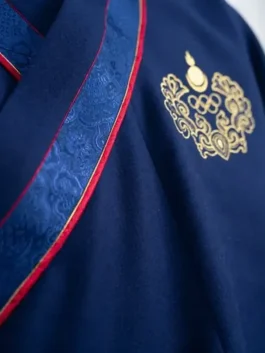 Detailed view of the Milano Cortina 2026 Team Mongolia mens outfit, highlighting the premium navy fabric and gold embroidered ceremonial deel crest.