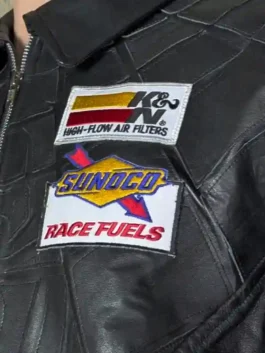 Close-up of the embroidered patches and web-stitched leather on a superhero-inspired moto jacket.