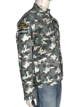 Close-up of the Supreme and Vanson patches on a camouflage Cordura jacket highlighting the premium thread work.