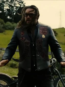 Jason Momoa wearing the wrecking crew jason momoa leather vest with custom biker patches and sunglasses while standing outdoors.