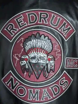 Close-up of a premium leather biker vest highlighting the detailed embroidery and high-quality suiting construction.