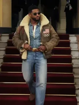 Usher in the Olympics 2026 Usher jacket for sale, styled with denim and a gold buckle belt while walking down a red-carpeted staircase.