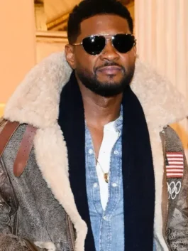 Close-up of Usher wearing the Olympics 2026 Usher Shearling Leather Jacket with a black scarf and sunglasses at the Team USA event.