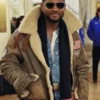 Olympics 2026 Usher Shearling Leather Jacket worn as a complete outfit with denim jeans and a dark scarf.