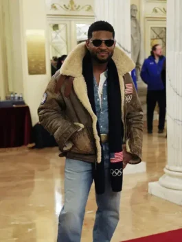 Usher posing in the Usher Olympics 2026 shearling jacket. This men’s shearling leather jacket Olympics 2026 style features a thick cream collar.