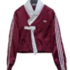 Women's maroon wrap-style fusion jacket with white sleeve stripes.