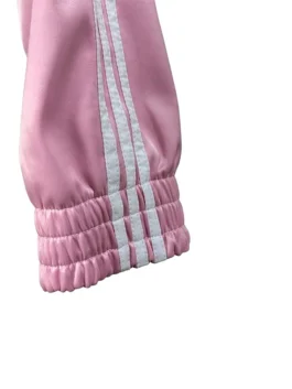 Cropped pink fusion coat with white ribbon and sleeve detailing.