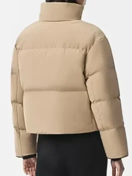 Jessy Schram Chicago Med S10 Puffer Jacket back view highlighting professional panels and luxury beige drape.