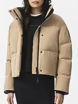 Jessy Schram Chicago Med S10 Puffer Jacket front view in professional beige polyester with a luxury snap tab closure.