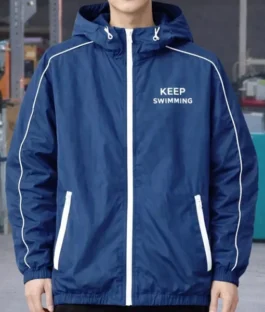 Keep Swimming BTS Jacket in rich deep blue nylon with bold white accents, elasticized hem and a sharp hooded full zip everyday athletic silhouette.
