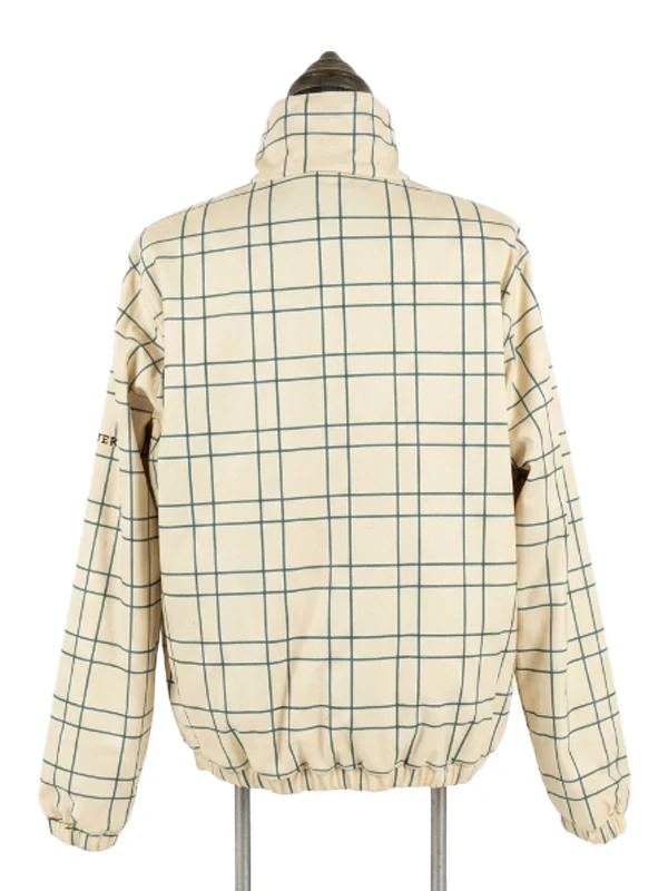 Rear profile view of the cream and green grid check pattern side of the Masters reversible quarter-zip jacket on a mannequin.