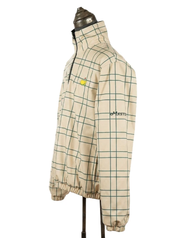 Left side profile view of the cream grid patterned side of the Masters reversible jacket, showing the sleeve embroidery and tournament chest logo.