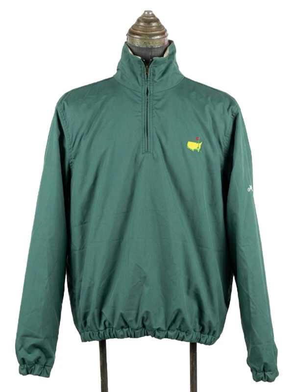 Front product view of the solid green side of the Masters reversible quarter-zip jacket, showing the classic yellow tournament map logo.