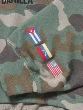 Gap Katseye Daniela Hoodie in camo fleece with professional sleeve embroidery and hooded collar.