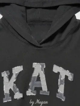 Gap x Katseye Megan Hoodie front view in smooth black fleece with a clean hooded collar and a relaxed pullover silhouette full of everyday cool.