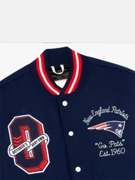 OVO New England Patriots Varsity Jacket highlighting professional navy blue panels and luxury fabric integrity.