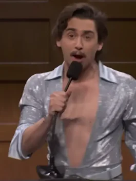 Saturday Night Live Marcello Hernandez Sequin Jumpsuit in sparkling grey sequin fabric with a bold shirt style collar and a confident full length everyday silhouette.