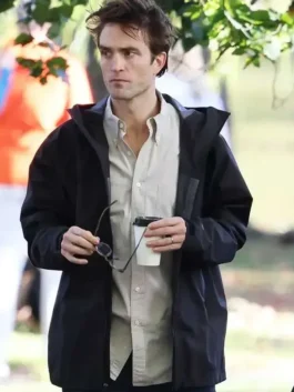 The Drama Robert Pattinson Black Jacket in lightweight black parachute fabric with a hooded collar and a clean relaxed zip-up everyday silhouette.