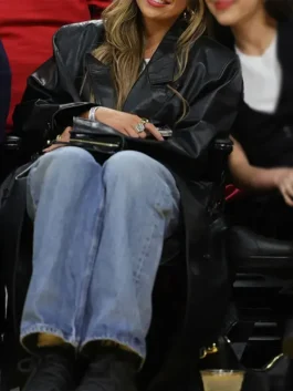 Full look of Tate McRae Black Leather Coat with long black leather design and casual denim outfit styling