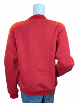 Rear view of a plain red mockneck sweatshirt on a mannequin paired with blue denim jeans.