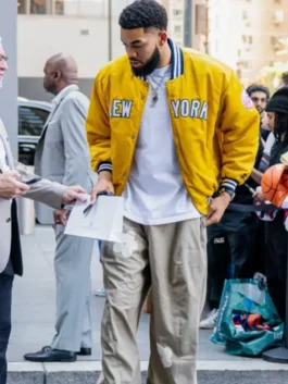 Karl-Anthony Towns New York Knicks Yellow Jacket in yellow satin featuring rib knitted collar, snap tab button closure, full length sleeves and rib knitted cuffs and hem