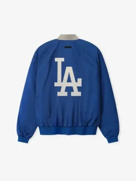 LA Dodgers Fear of God Essentials Half Zip Jacket back view in bold blue polyester with clean FOG x Dodgers detailing and a rib knitted hem silhouette.