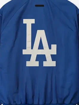 LA Dodgers Fear of God Essentials Half Zip Jacket in rich blue polyester with a rib knitted collar and LA Dodgers x Fear of God Essentials bold everyday presence.Rep your LA Dodgers pride in bold Fear of God style with the iconic LA Dodgers Fear of God Essentials Half Zip Jacket in blue.