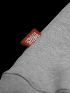 TMS Grey Hoodie highlighting professional kangaroo pockets and luxury rib knitted cuffs.