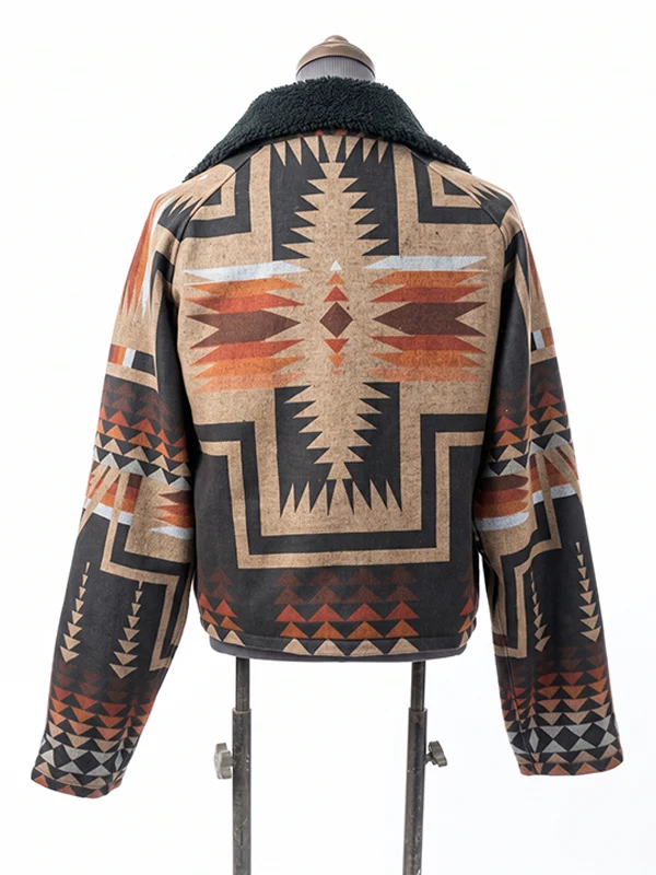 Rear view of the Dutton Ranch Beth Dutton Western Print Jacket on a mannequin, showcasing a large, centered Aztec cross graphic in rust, orange, tan, and black.