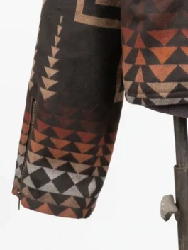 Close-up of the long sleeve on the Dutton Ranch Beth Dutton Western Print Jacket, featuring an integrated vertical wrist zipper and geometric tribal patterns in earth tones.