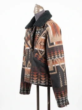 Close-up front view of the torso section of the Dutton Ranch Beth Dutton Western Print Jacket, highlighting the asymmetrical brass zipper, angled slip pockets, and tribal pattern.