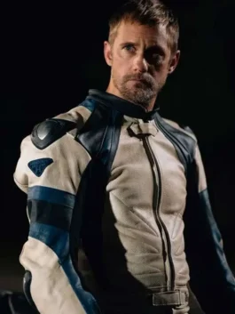 Alexander Skarsgard wearing a white leather motorcycle racer jacket with blue and black shoulder inserts and armor detailing