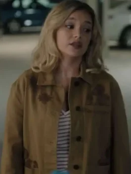 Live scene still of Amalia Williamson wearing the casual brown cotton embroidered jacket over a striped top in a dimly lit setting.
